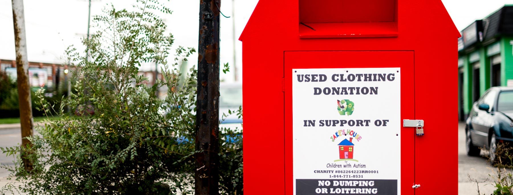 big, red clothing donation bin outside