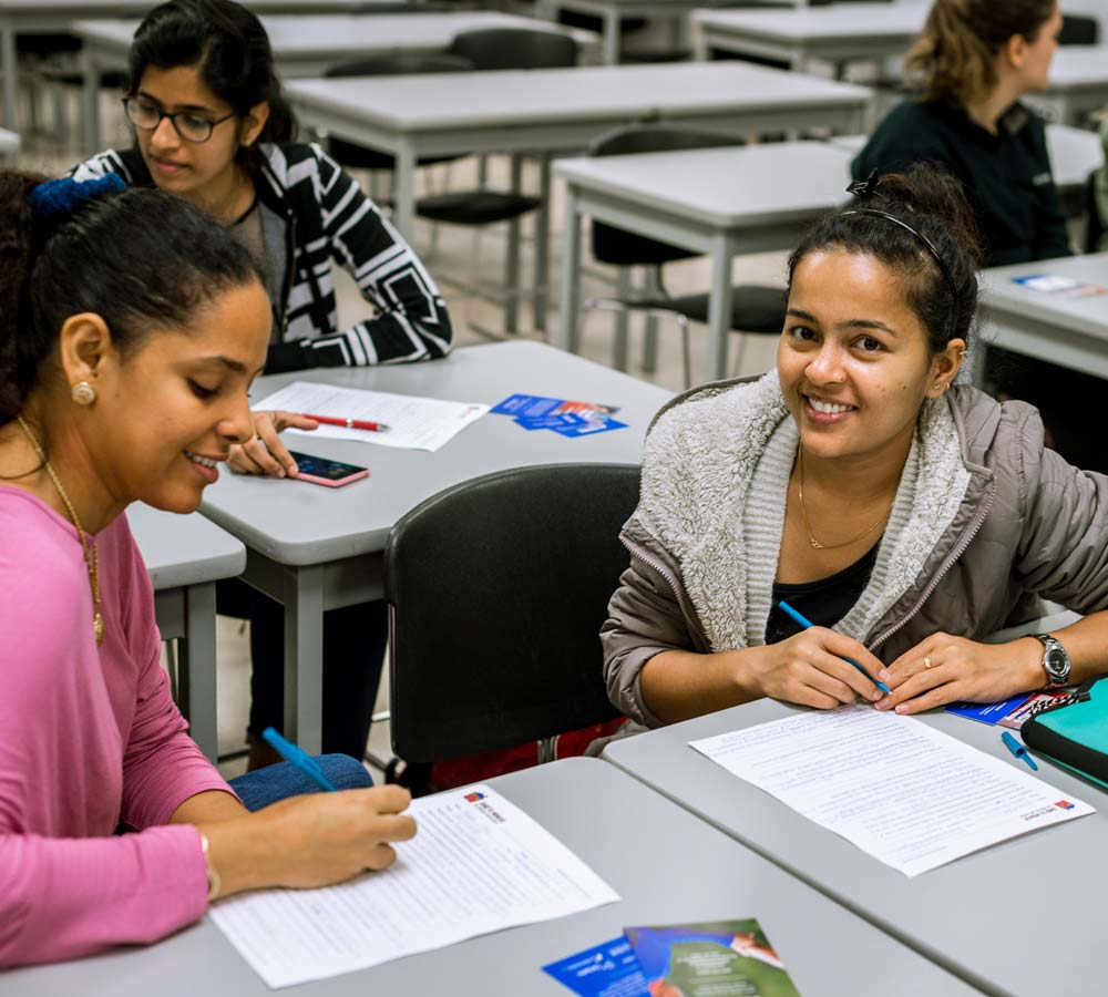 Two people smiling at a desk