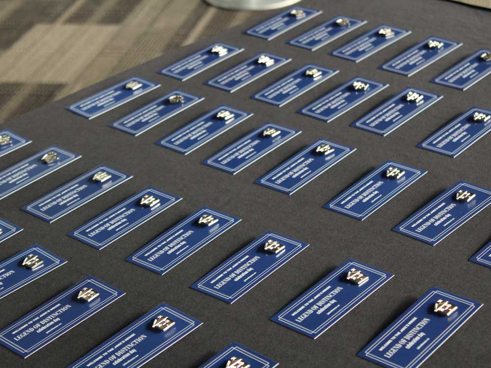 table with group of blue jake's house badges organized in a grid on top