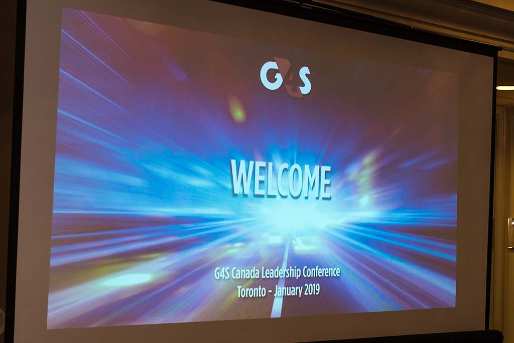 a projector screen showing a welcome slide
