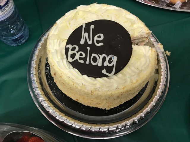 a cake with the words "we belong" written on it in icing