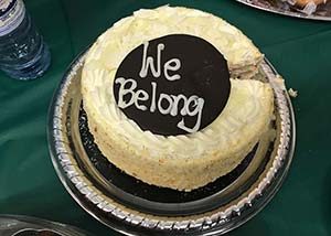 a cake with the words "we belong" written on it in icing