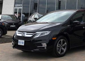 Honda Odyssey parked in front of dealership