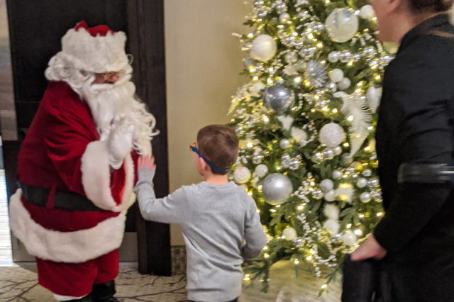 young boy high-fiving Santa Claus