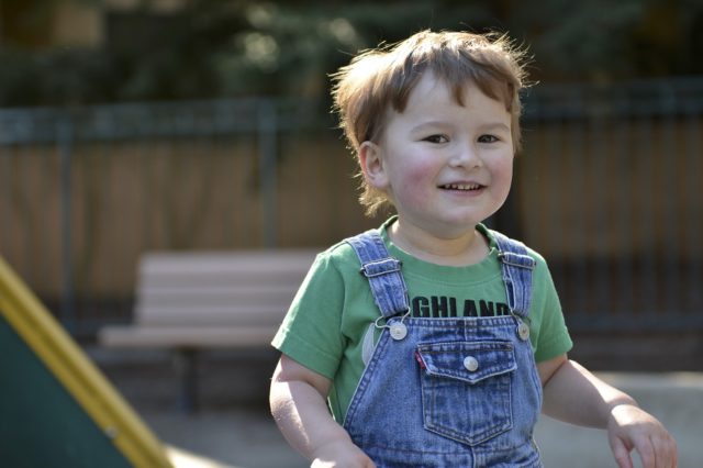 Signs your child has autism Boy in overalls